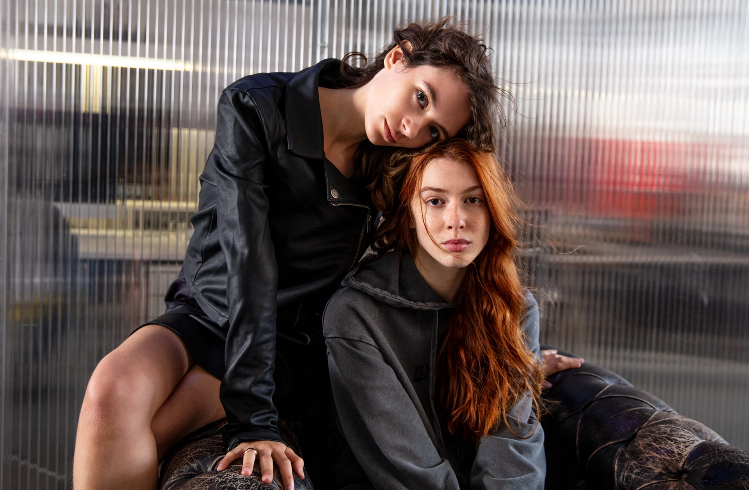 LOSAN - Fall winter 2022 collection, two women sitting on a couch wearing shirt and hoodie